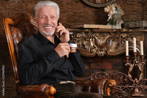 Portrait of a smiling senior man drinking coffee