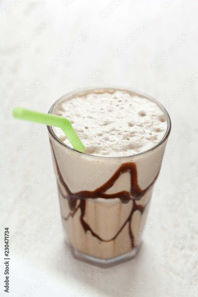 White Frappe Coffee Glass with iced drink on a light wooden table. White Frappe Coffee Glass with iced drink on a light wooden table.