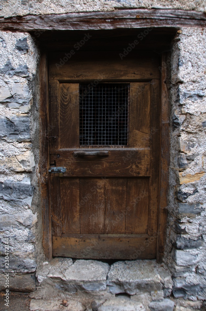 Rustic doorway of old dwelling in Cabbio, village in Ticino (Italian Switzerland)