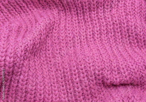 Texture of a pink knitted sweater closeup  red knitted wool