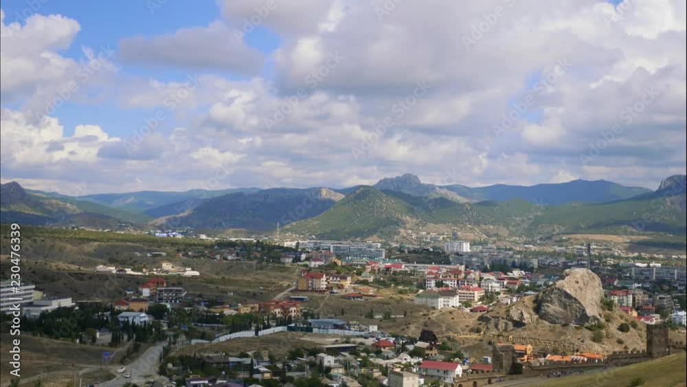 Mountains against the blue sky with white clouds. Cirrus clouds run across the blue sky. Mountains against the blue sky with white clouds. Cirrus clouds run across the blue sky.