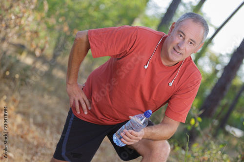 man pausing from exercise to drink water