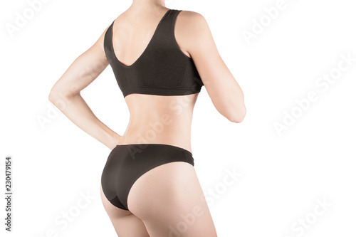 Female cropped fit back and buttocks in black panties and top, isolated on white.