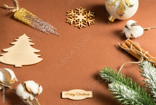  inscription, snowflake, Christmas decorations, green spruce branch, cotton branch, artificial icicle, Christmas decorations, ball, cinnamon sticks, place for inscription on brown background