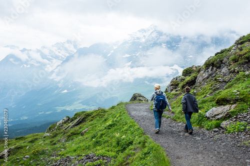 Hikers on trail near Kleine Scheidegg, Grindelwald, Bernese Oberland, Switzerland, Europe