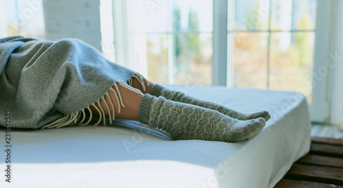 Feet in warm socks peeking out from under the blankets.