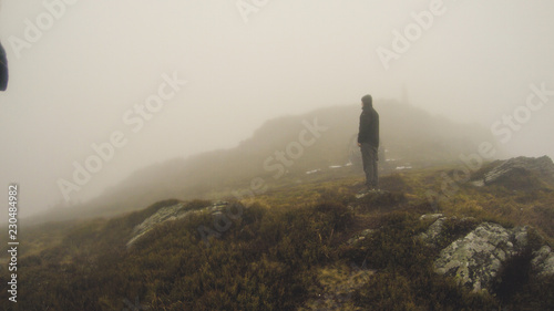 The guy in the fog on top of the mountain. Traveler Secret mountains. Ukrainian Carpathian Mountains.