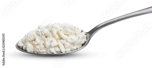 Cottage cheese in spoon isolated on white background