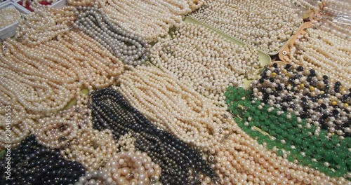 Natural pearls, on a counter top at a public market stall photo