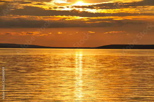 The sun setting over Waskesiu Lake in Prince Albert National Park of Canada. photo