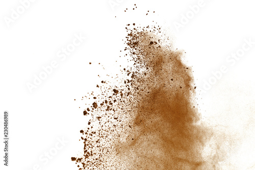 Brown powder explosion on white background. Dry soil splatted isolated. Paint Holi.
