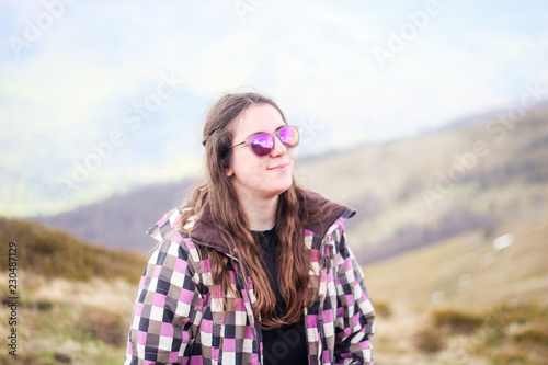 Portrait of a lucky girl in the mountains.Ukrainian scenic Carpathians. Mountain trip. Traveling with friends. Landscapes from the top. Trees. Autumn