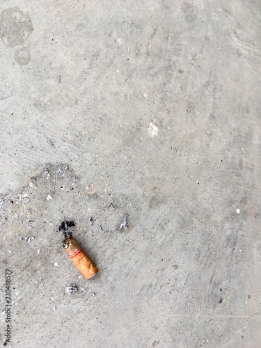 One cigarette on the cement floor - The cigarettes were pumped and thrown on the floor.