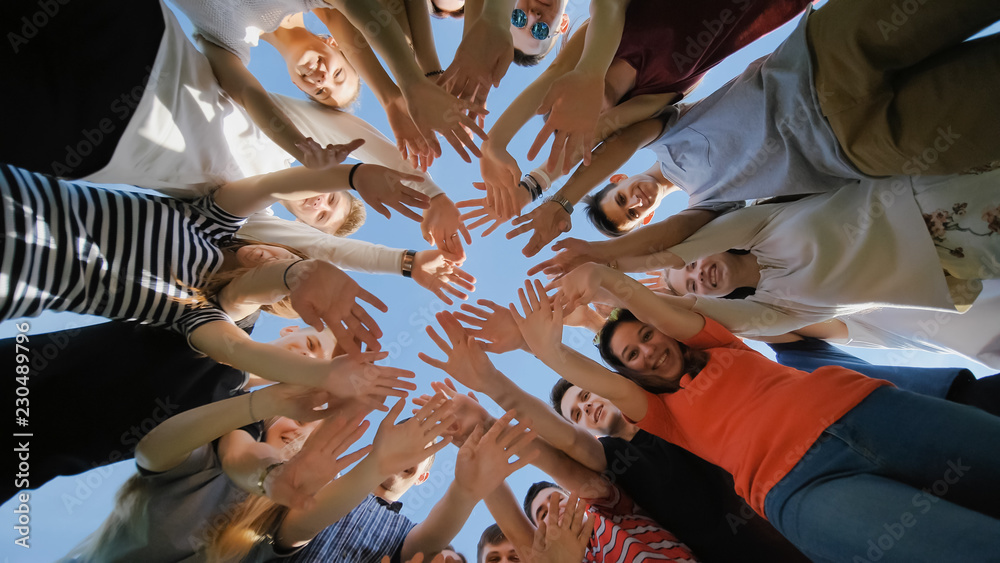 Fototapeta premium School class collection. The pupils wave their hands and run. College Students Teamwork Stacking Hand Concept. Nineteen friends.