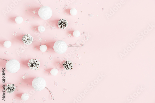Christmas composition. Christmas pink and white decorations on pastel pink background. Flat lay, top view, copy space