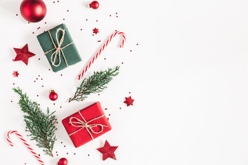 Christmas composition. Gifts, fir tree branches, red decorations on white background. Christmas, winter, new year concept. Flat lay, top view, copy space