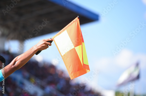 Bild auf Leinwand Assistant referee hold flag , offside signal.