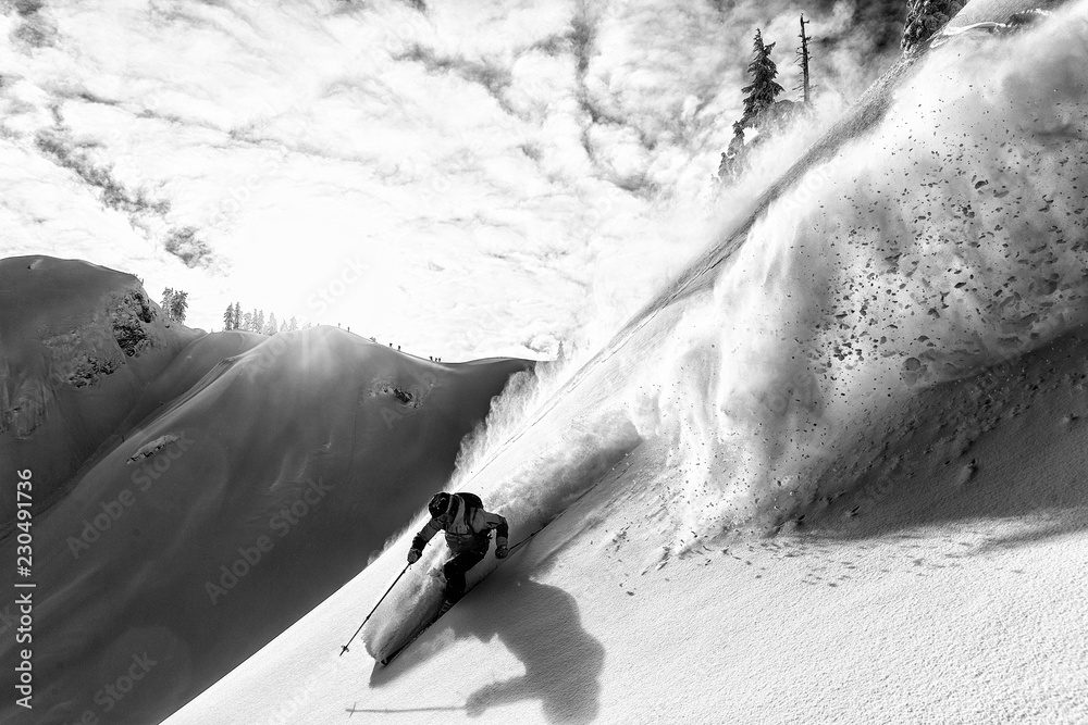© Grant Gunderson - Skier skiing down a steep mountain