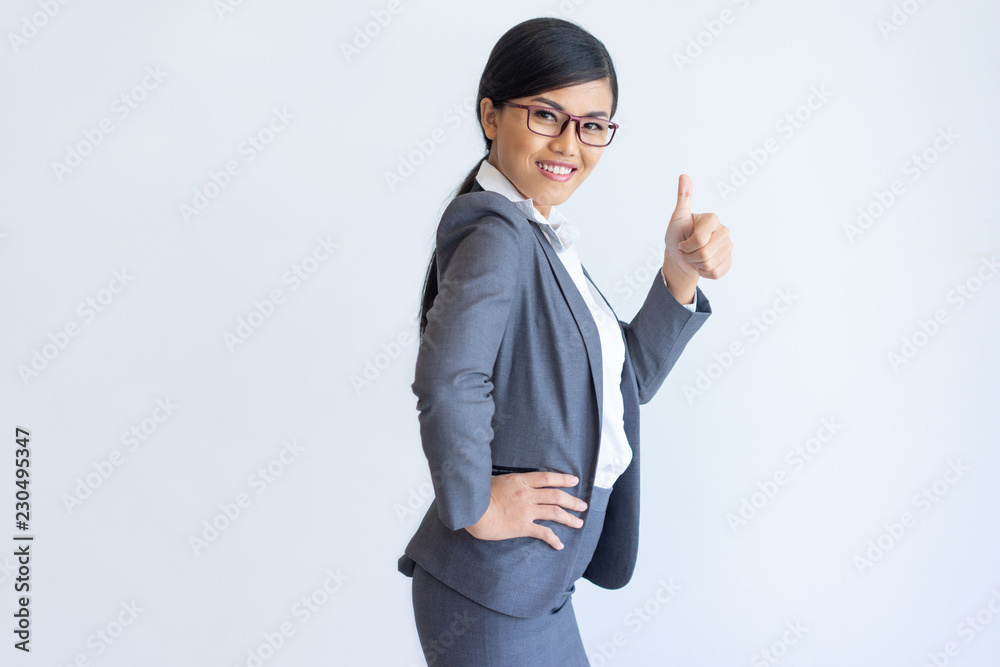 Cheerful Asian business lady recommending product, service, offer. Beautiful woman in formal suit gesturing Like. Approval and customer feedback concept Cheerful Asian business lady recommending product, service, offer. Beautiful woman in formal suit gesturing Like. Approval and customer feedback concept