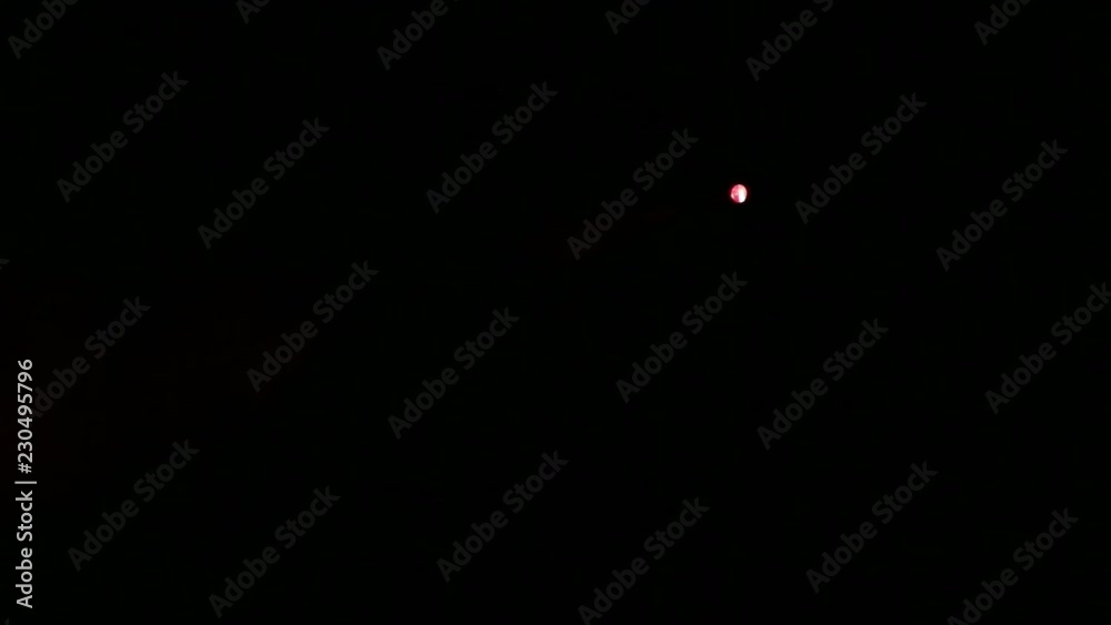Scene illumination with a red ray of light from a spotlight in the smoke from a smoke machine.