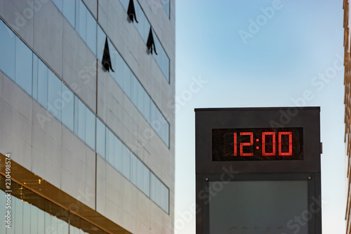electronic display with a clock between buildings