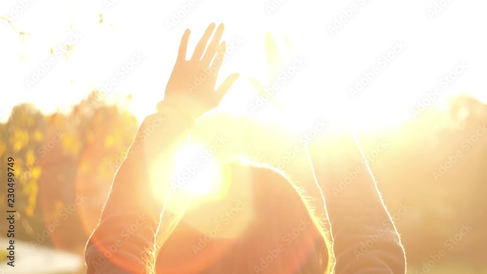 Woman hands touching the sunlight