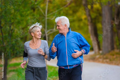 Smiling senior couple jogging in the park