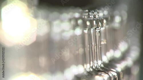 Alcohol factory, the conveyor moving bottles, beautiful rasfokus, close-up photo