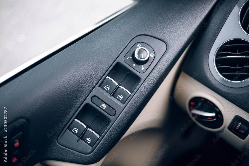 Mirror control knob in a modern car. Auto window button control inside driver place.