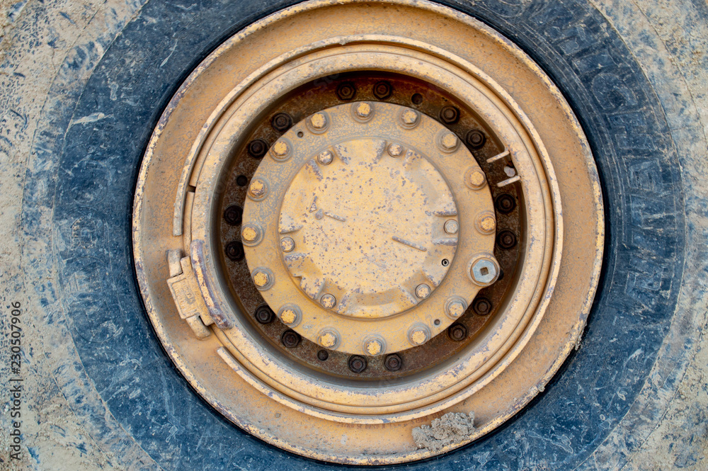 Fototapeta premium Large yellow rimmed tire from a construction vehicle