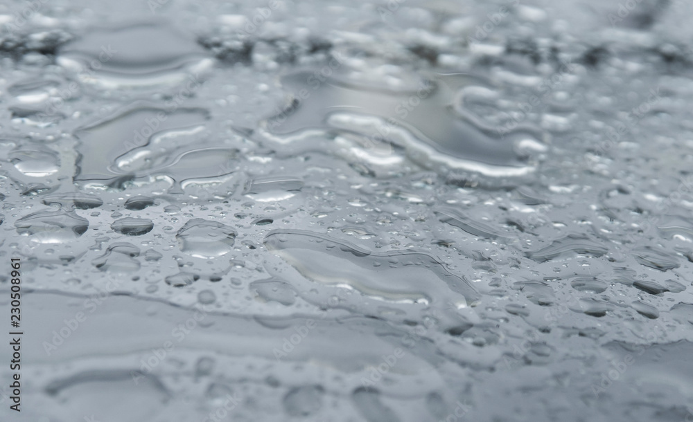 Natural water drops on a glass table after rain. Natural water drops on a glass table after rain.
