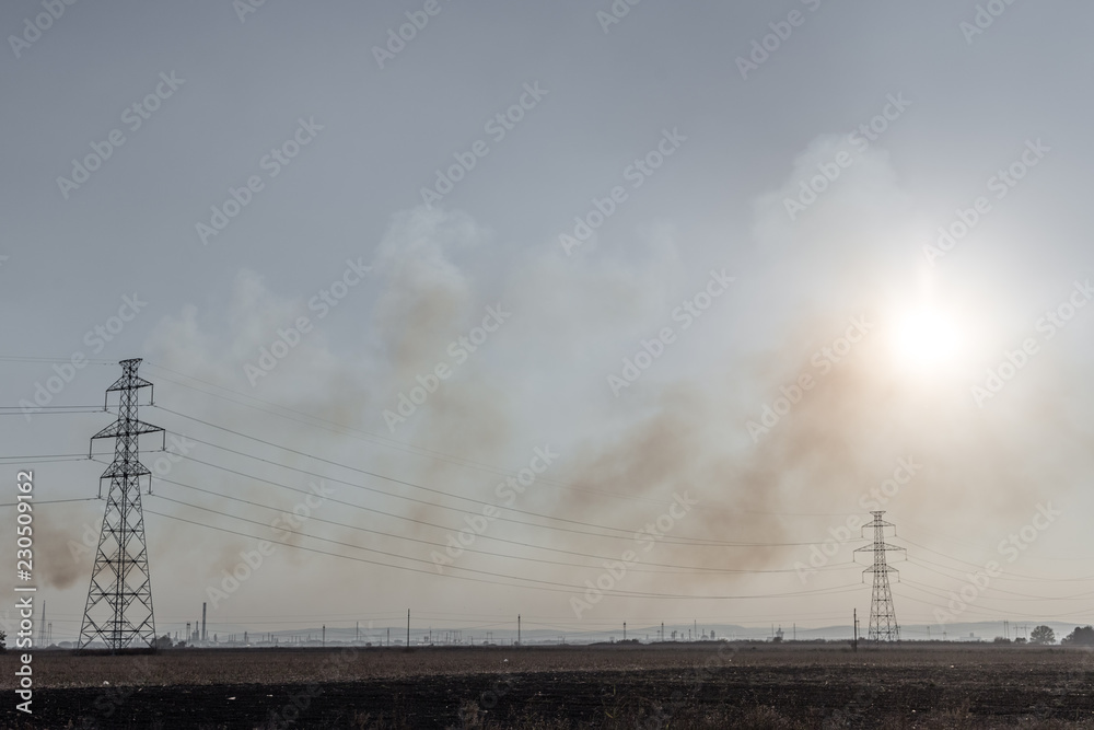 Smoke of burning corn field.Burning corn field after the harvest. Smoke of burning corn field.Burning corn field after the harvest.