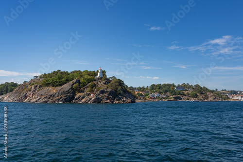 Rocky archipelago hills with a lighthouse 