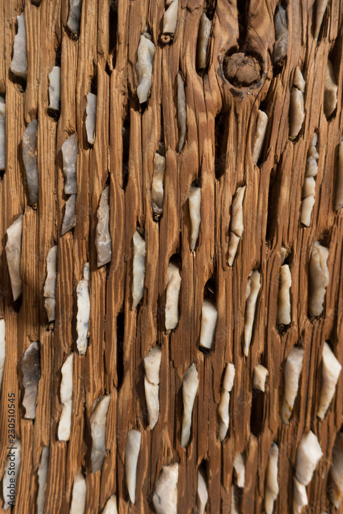 Fototapeta premium Perforated wooden surface with stones