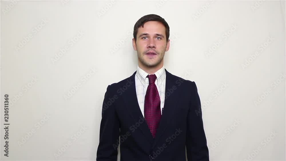 Handsome young businessman actively expresses joy, makes a gesture with his hand and says yes.Portrait on a white background. Handsome young businessman actively expresses joy, makes a gesture with his hand and says yes.Portrait on a white background.