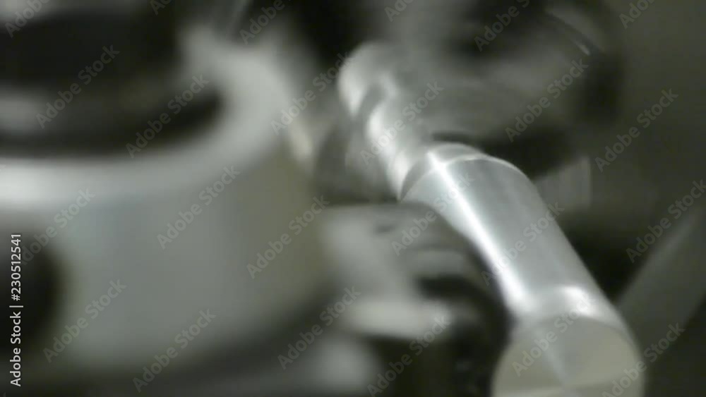 Knurling a steel cylinder on a metal lathe in a metal fabrication shop Knurling a steel cylinder on a metal lathe in a metal fabrication shop