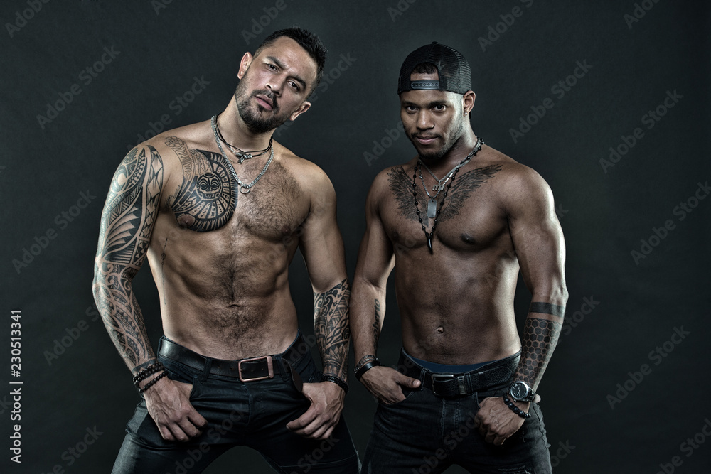 Men tattooed muscular body. Fashion models muscular chest. Sportsmen  muscular belly posing. Sport and bodycare. Muscular and masculine guys look  confident. African and hispanic men sexy bare torso Stock Photo | Adobe