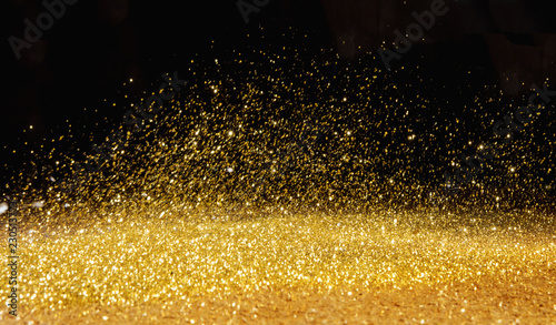 Golden powder scattered over the dark background