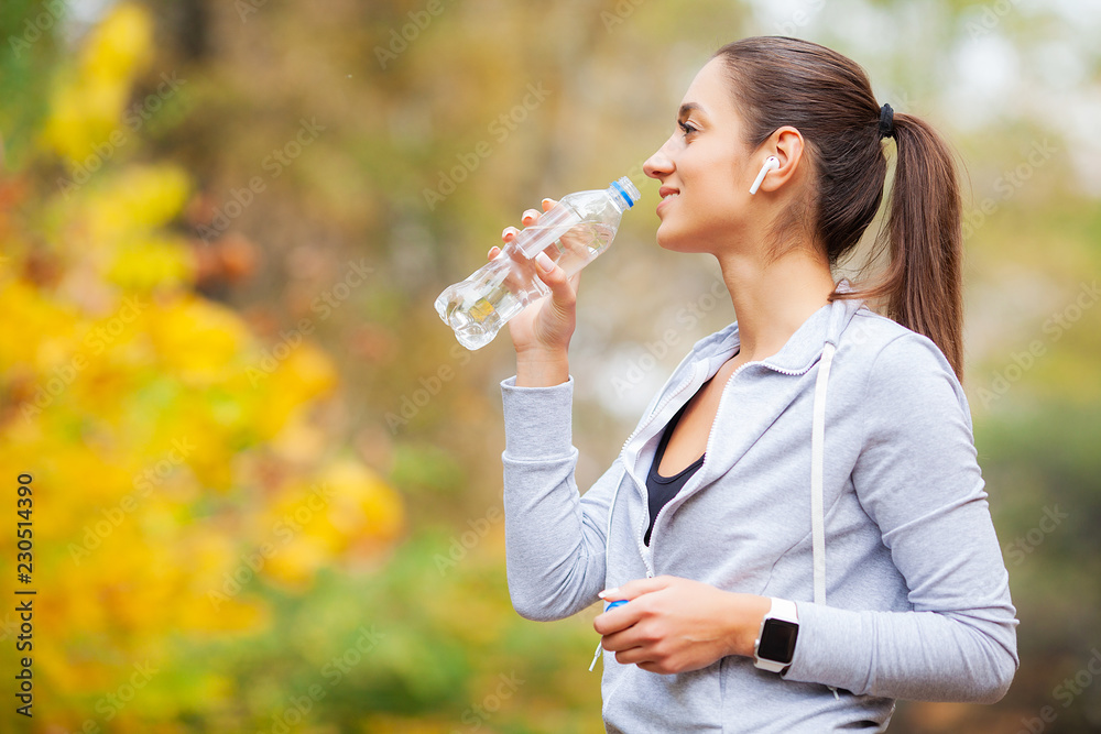 Sport outdoor. Woman Drinking Water After Running - obrazy, fototapety, plakaty 
