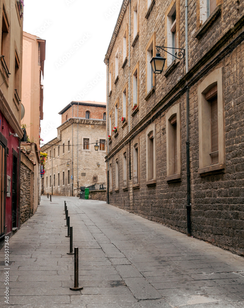 Paved street of old houses and lamps in the Spanish city of Vitoria