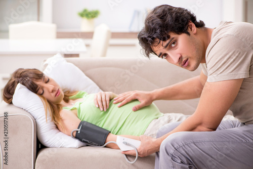 Husband checking pregnant wife's blood pressure © Elnur
