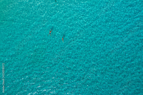 Swimmers from above - a drone shot of sea surface