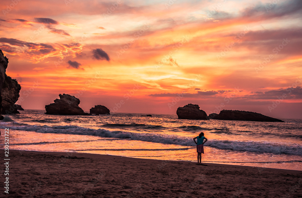 july 07 2018 Biarritz , France . Girl enjoying a summer sunset on the beach called Grand Plage in Biarritz, France .