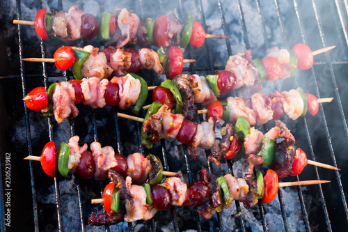 Kebabs being grilled on open fire outside / called a braai in South Africa