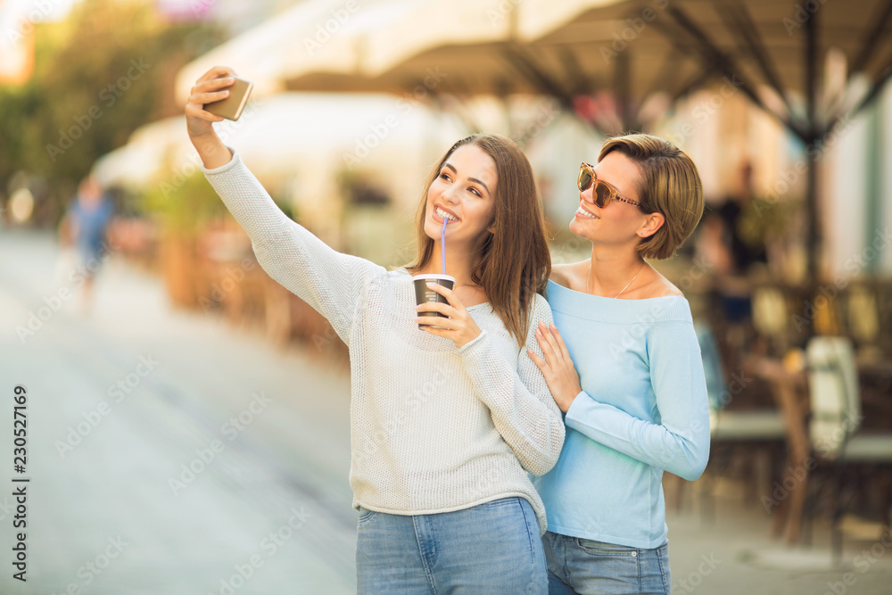 Fototapeta premium Two beautiful young women taking a selfie