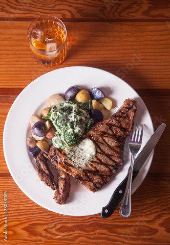 Plate of steak with salad and potatoes photo