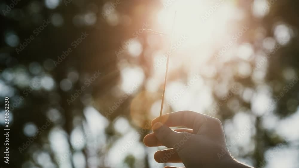 Small christian cross from sticks on a bokeh background