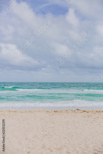 Miami beach by ocean under clouds in Miami, Florida, USA