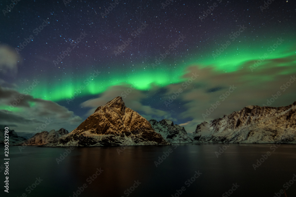 Northern Lights in the mountains of Reine, Norway. Lofoten Islands