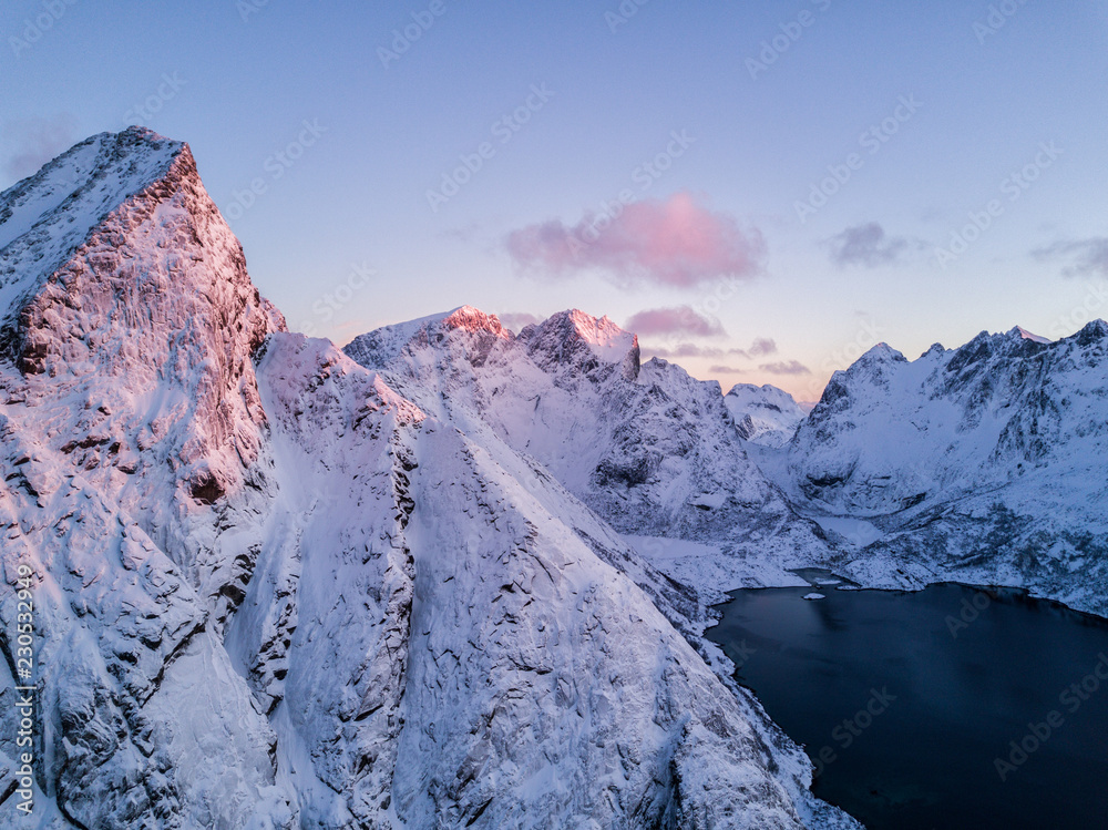 Fototapeta premium Aerial drone photo - Beautiful sunrise over the mountains of the Lofoten Islands. Reine, Norway